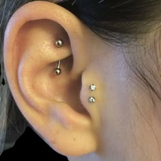 a woman with three piercings on her ear