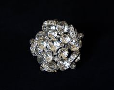 "This is one gorgeous rhinestone brooch.  So very bright and sparkly. \"Eisenberg\" stamped on the back. *Please note: Two of the very small rhinestones surrounding the center stone are missing (see pics) Width - 1 3/4\" diameter Find more vintage brooches and pins from my shop here! ~ https://www.etsy.com/shop/AnnWoodallStudios?ref=seller-platform-mcnav&section_id=22220795 If you are interested in a vintage item, please examine the photographs carefully and feel free to contact me with any ques Crystal Brooches With Rhinestones For Anniversary, Anniversary Costume Jewelry Brooches With Rhinestones, Anniversary Rhinestone Costume Brooches, Crystal Brooches With Sparkling Stones For Anniversary, Anniversary Crystal Brooches With Sparkling Stones, Velvet Dress Long, Sterling Silver Brooch, Professional Jewelry, Faux Stone