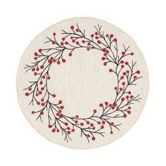 a white rug with red berries on it and a circular design in the middle,