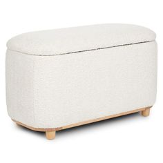 a white ottoman with wooden legs and an upholstered cushion on the back side