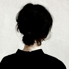 the back of a woman's head with her hair in a bun