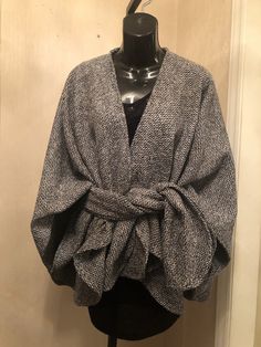 Wool and polyester blend Boucle Crop length Classic wrap with signature matching scarf. Handcrafted, Dry clean Chic Wool Poncho For Winter, Spring Faux Wrap Cardigan, Chic Wool Cape For Fall, Elegant Fall Poncho For Workwear, Elegant Fall Poncho For Work, Chic Wrap Shawl For Fall, Elegant Fall Workwear Poncho, Chic Fall Wrap Shawl, Elegant Cardigan For Cold Weather