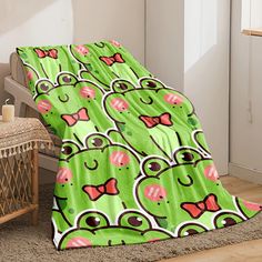 a bed with a green and pink bedspread covered in cartoon character designs on it