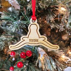 a wooden ornament hanging from a christmas tree