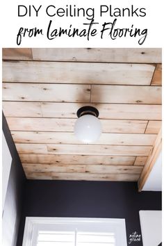 the ceiling is made out of wood planks and has a light fixture above it