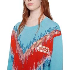 Opulent details, like glimmering feather and drop appliques, wrap around the shoulders of this cotton sweatshirt.Light blue felt cotton jersey with red maxi chevron motif.Embroidered beads.Gucci in SEGA fontCrewneck.Oversize fit.Composition: Cotton 100%Made in Italy. Gucci Blue Casual Sweater, Gucci Casual Blue Sweater, Casual Blue Gucci Sweater, Blue Gucci Tops For Fall, Gucci Embroidered Logo Long Sleeve Sweatshirt, Spring Blue Gucci Tops, Blue Gucci Tops For Spring, Gucci Long Sleeve Tops With Embroidered Logo, Gucci Blue Long Sleeve Sweater