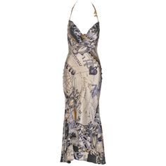 This Roberto Cavalli silk dress features a halter neckline with gold chain straps. The fabric showcases an ivory and black base with intricate astrological-themed prints, including constellations, stars, and zodiac symbols. The cowl neckline drapes elegantly, while the fitted bodice and flared hem create a flattering silhouette. The backless design accentuates the sleek form, and the calf-length skirt offers a slightly flared finish. ▪ Brand: Roberto Cavalli ▪ Creative Director: Roberto Cavalli ▪ Collection: Fall-Winter 2003 ▪ Fabric: Silk ▪ Size: 'XS' ▪ Made in: Italy ▪ Condition: Very Good ▪ Mannequin: 183 cm / 6ft ---------------- Condition Grading Guidelines:  ▪ Pristine - No signs of wear with inclusion of original packaging ▪ Excellent - Very slight signs of wear with no visible flaw Vintage Roberto Cavalli Dress, Dress With Chain Straps, Roberto Cavalli Dress, Cavalli Dress, Silk Halter Dress, Calf Length Skirts, Printed Silk Shirt, Fairytale Dress, Silk Mini Dress