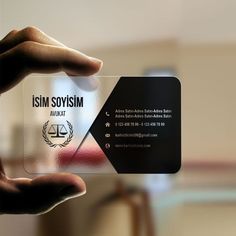 a person holding up a business card with an image of the symbol of justice on it