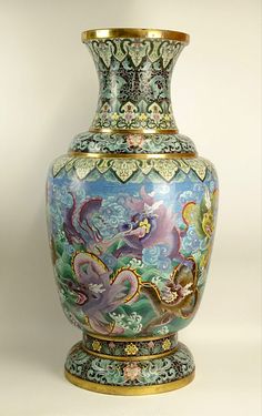 an ornate vase is sitting on a white surface