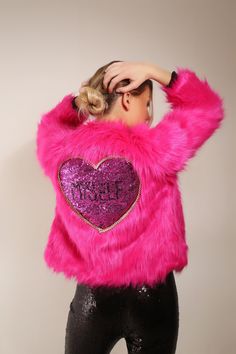 "- Threaded Tribe - ♡ LIMITED EDITION ♡ Fuchsia hot pink faux fur jacket. Hip/Waist length. Casual snug fit! Large pink sequinned heart on back bordered with multicoloured twisted kitschy trim. Hand embellished black sequin \"Myself\" lettering on back. What's more important than.. YOU! Spread the self love and be proud of who you are! The perfect jacket to make a statement. Wear at a party, festival, or day to day. Keep cosy and warm this winter in style. Note: Garment Care Due to the delicate Party Long Sleeve Faux Fur Coat, Long Sleeve Faux Fur Coat For Parties, Party Fur Coat With Faux Fur Trim, Trendy Pink Faux Fur Coat, Glamorous Long Sleeve Fur Coat For Party, Pink Fluffy Long Sleeve Fur Coat, Fitted Pink Fur Coat For Fall, Fluffy Long Sleeve Party Outerwear, Pink Fitted Long Sleeve Fur Coat