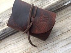 a brown leather case sitting on top of a wooden table