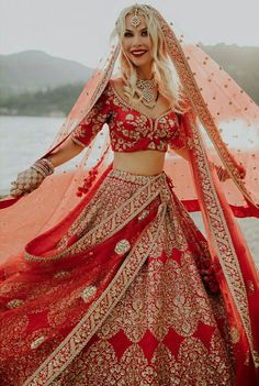 a woman in a red and gold wedding outfit