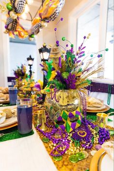 the table is set with purple and green decorations