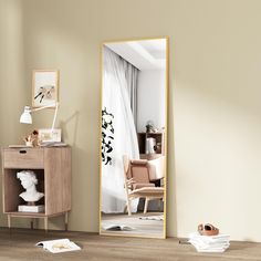 a mirror sitting on top of a wooden floor next to a dresser