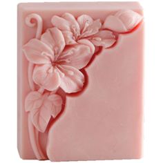 a pink soap bar with flowers on it