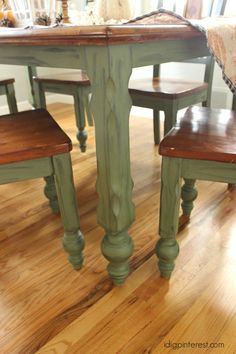 a dining room table and chairs painted green