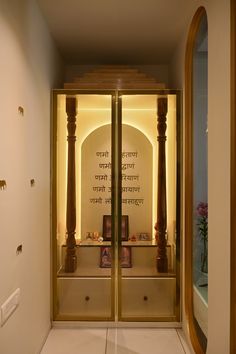 an open door leading into a room with white walls and gold trimmings on the doors