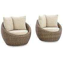 two wicker chairs sitting next to each other