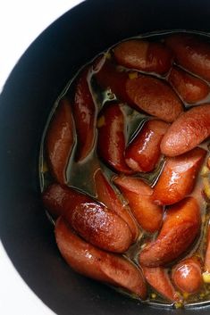 hot dogs are being cooked in a pot