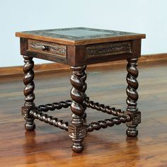 an old wooden table with two drawers on it