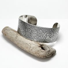 "Cuff Bracelets are my favorite jewelry pieces to wear, and I'm in love with my new floral bracelets! This cuff is made using a vintage flower pattern that I impress into the metal, then sand, form and finish. The pattern will vary in placement from piece to piece, and is equally awesome on each cuff. Makes a perfect gift for the gardener, nature lover, or floral enthusiast in your life! Available in sterling silver, copper, or brass, with a shiny or matte finish, and in assorted widths--it's a great idea to cut out a strip of paper in the width you'd like and lay it on your wrist to see how it looks before ordering. Each cuff is about 6 inches long, and will fit most wrists. If you need a custom length, please message me. Artist signed, ships in my signature gift box, ready for giving, or Adjustable Etched Cuff Bracelet As Gift, Nature-inspired Cuff Bangle Bracelet As Gift, Nature-inspired Cuff Bangle Bracelet For Gifting, Nature-inspired Bangle Cuff Bracelet As Gift, Bohemian Etched Cuff Bracelet As Gift, Etched Cuff Jewelry As A Gift, Bohemian Etched Cuff Bracelet Gift, Bohemian Stamped Cuff Bracelet For Gift, Bohemian Stamped Cuff Bracelet Gift