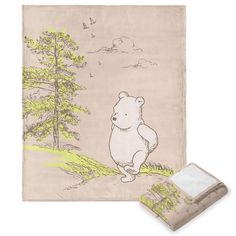 a towel with a drawing of a bear on it next to a pillow and envelope