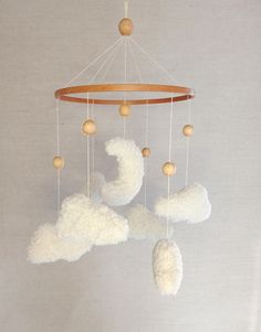 a white cloud mobile hanging from the ceiling