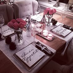 the table is set with place settings for two people to sit down and have their name written on them