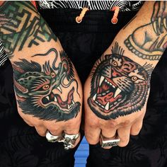 two men with tattoos on their hands and one has a tiger tattoo on his arm