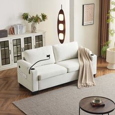 a living room with a white couch and coffee table