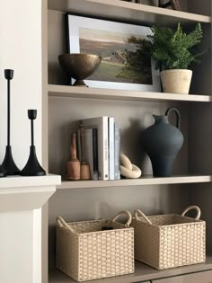 the shelves are filled with vases, books and other decorative items in baskets on them