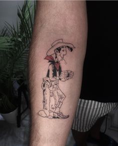 a man's leg with a cartoon character tattoo on it