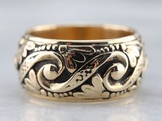 Crafted by the Art Carved company in the mid-1900s, this vintage yellow gold band features an ornate pattern of swirls, dots, and botanical motifs in a comfortable width. This will look nice all on its own, stacked with other bands or up against a vintage style engagement ring! Metal: 14K Yellow Gold Width of Band: 10.2 mm Height off Finger: 2.4 mm Ring Size: 7.50 Marks: "14K{ARTCARVED" Stamped on the inside band Luxury Traditional Carved Rings, Luxury Artisan Carved Rings, Mens Ring Antique, Posey Ring, Ornate Pattern, Botanical Motifs, Vintage Wedding Jewelry, Vintage Style Engagement Rings, Band Art