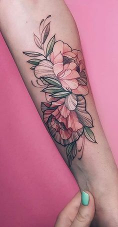 a woman's arm with a flower tattoo on it