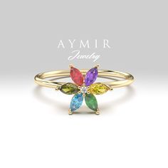 14K Solid Gold Birthstone Ring: This gemstones and solid gold ring is finished with 6 marquise birthstones and 1 round natural diamond. A highly polished finish completes the look of this personalized ring. ♦ If you want this ring with different colored gemstones or set in 8K Gold, 14K Gold or 18K gold, please send us a message and we will quote you a price with the stones you want F E A T U R E S ▸ Made to Order ▸ Custom Gold Color: Yellow Gold, Rose Gold, White Gold ▸ Band Width: 1.20mm ▸ Mate Family Valentines, Family Birthstone Ring, Family Valentines Day, Colored Gemstones, Ring Flower, Zierlicher Ring, Personalized Ring, Solid Gold Rings, Personalized Rings