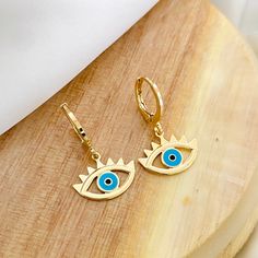 ⭐️Item Description: Hoop Size: 11 x 11mm Evil Eye Size: 10.5 x 15.5mm Material: 18K Gold Filled Benefits: Water & Tarnish Resistant, Hypoallergenic ⭐️About Our Hoops: Our hoop collection ranges in shape, size, and design in order to effectively draw attention to the beautiful features of your face. They have the power of making you feel stylish, powerful, and daring in all types of outfit ⭐️Care Instructions: 1. You may shower and sleep with your gold filled items but it is highly suggested to a Blue Drop Earrings, Gold Plated, Blue Gold Plated Drop Earrings, Single Blue Gold-plated Earring, Blue Single Gold Plated Earring, Blue Gold-plated Drop Earrings, Blue Hypoallergenic Small Hoop Huggie Earrings, Hypoallergenic Blue Small Hoop Huggie Earrings, Blue Small Hoop Earrings For Pierced Ears, Nickel Free Blue Gold Plated Earrings