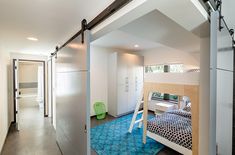 there is a bunk bed in the room with blue carpet on the floor and white walls