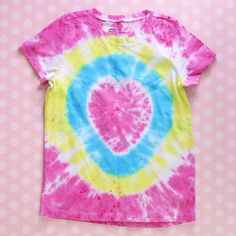 a pink, blue and yellow tie - dye shirt with a heart on it