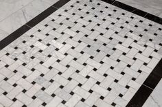 black and white tiles on the floor in a bathroom