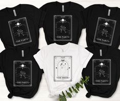 five t - shirts with the tarot card on them, one is black and three are white