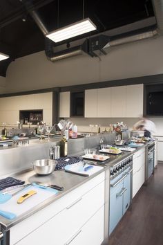 a chef is preparing food in a large kitchen