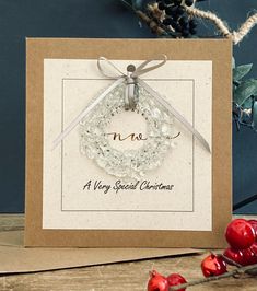 a merry special christmas card with a handmade wreath and ribbon tied around the front