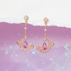 Lose yourself in the light and mystery of the skies above! Our Lost In Orbit Dangle Earrings are a wonderful spin on the classic celestial motif. These earrings feature a delicate pear shaped gradient stone that is absolutely mesmerizing. 18k gold plated, 18k rose gold plated, or rhodium plated over brass with a protec Fantasy Accessories Earrings, Celestial Teardrop Earrings Gift, Celestial Teardrop Earrings For Gift, Artistic Earrings, Moon Studs, Necklace Chain Lengths, Pretty Jewelry, Fantasy Jewelry, Copper Earrings