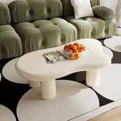 a white table topped with oranges on top of a black and white floor