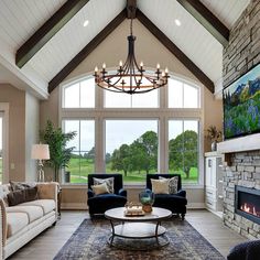 a living room filled with furniture and a flat screen tv mounted on the wall next to a fire place