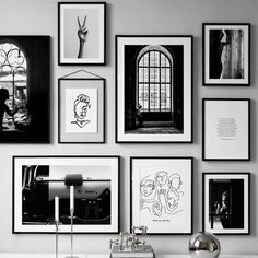 black and white photographs hang on the wall above a dresser