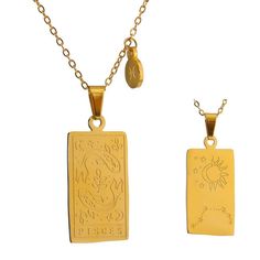 two gold pendants with an image of a child on them, one has a sun and the other is a moon