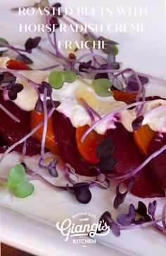 roasted beets with horseradish creme and fresh herbs on a white plate