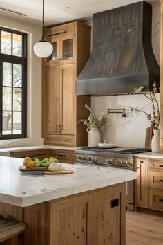 a large kitchen with wooden cabinets and an island in front of the stove top oven