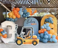 an outdoor area with balloons and decorations on the wall, including a golf buggy